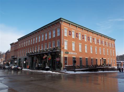 an old red brick building with lots of windows and snow on the ground ...