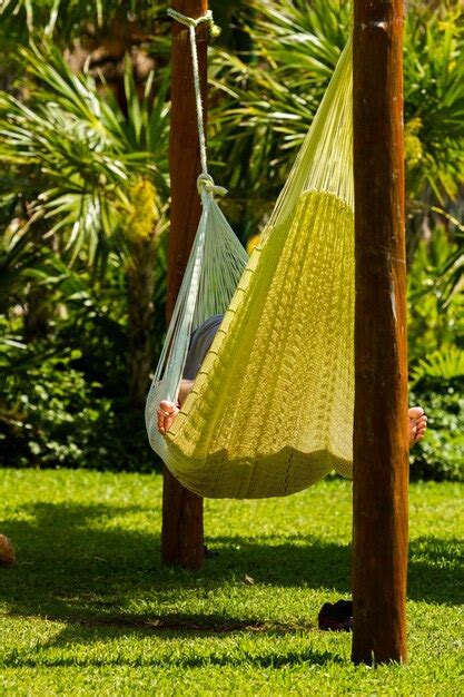 Premium Photo | Person relaxing in hammock.