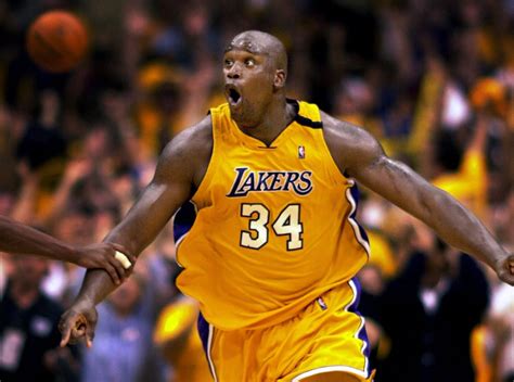 Shaq celebrates after the most famous alley-oop in NBA history : NBAimages