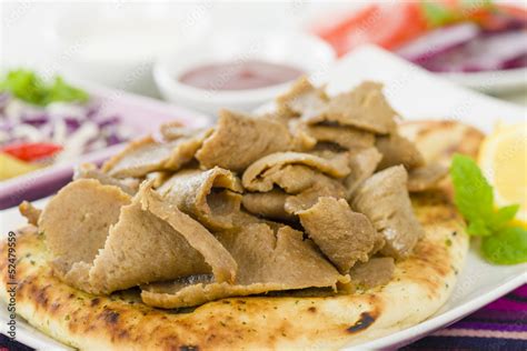 Donner Meat on Naan - Slices of donner meat on a flatbread Stock Photo ...