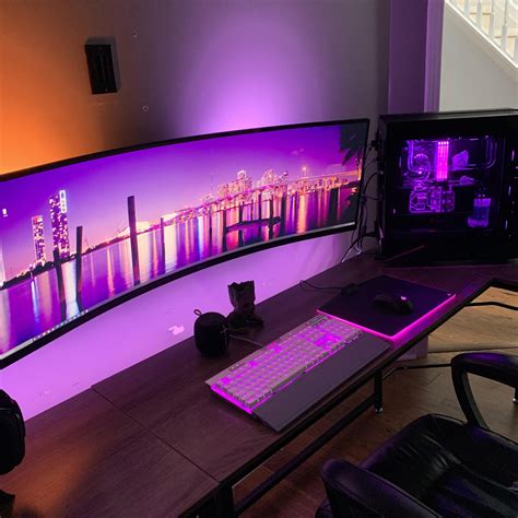 a desk with a keyboard, mouse and monitor on it in front of a purple background