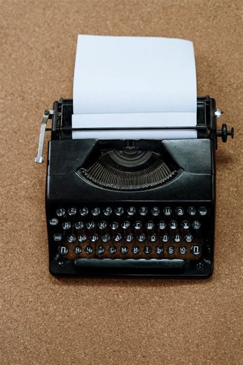 Black and White Typewriter on Brown Carpet · Free Stock Photo