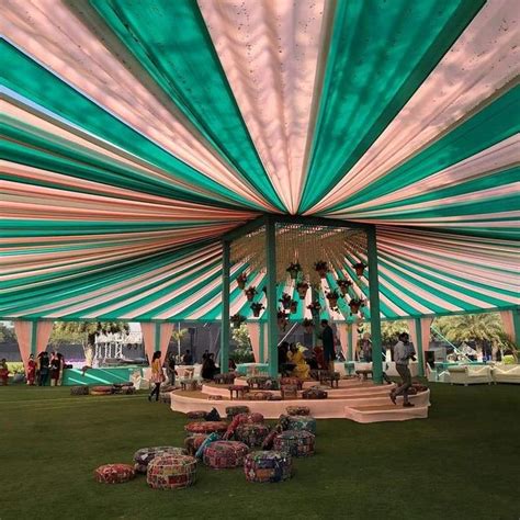 the inside of a large tent with people sitting under it