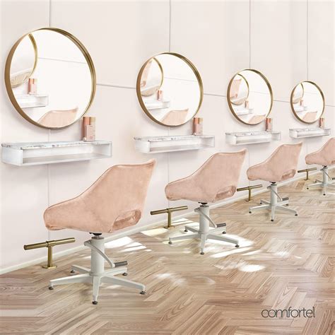 a row of chairs sitting in front of mirrors on the wall next to each other