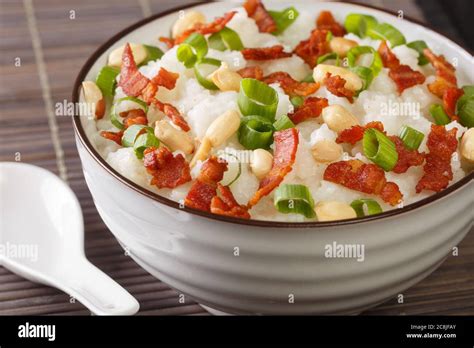 Ginger bacon Jook Rice Porridge close-up in a bowl on the table. horizontal Stock Photo - Alamy