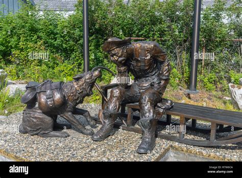 A sculpture of a prospector and his dog near the Alaska Geographic Museum Store, Skagway, Alaska ...