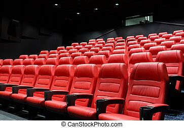 Empty movie theater with purple seats. An empty movie theater with rows of purple seats. | CanStock