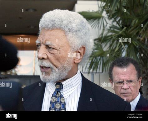 City of Oakland Mayor Ron Dellums, left, answers questions to media as ...