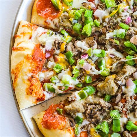 a pizza topped with lots of toppings on top of a pan