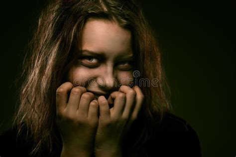 Girl Possessed By A Demon With A Sinister Smile Stock Photo - Image: 42654425