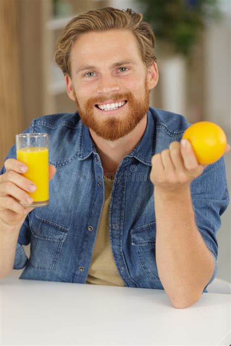 Man drinking orange juice stock image. Image of smile - 209802033