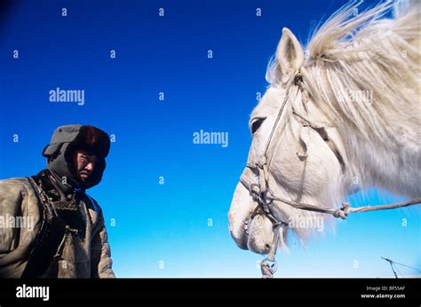 Mongolian houseman with his white horse, Xilin Gol Grassland, Inner Mongolia Autonomous Region ...