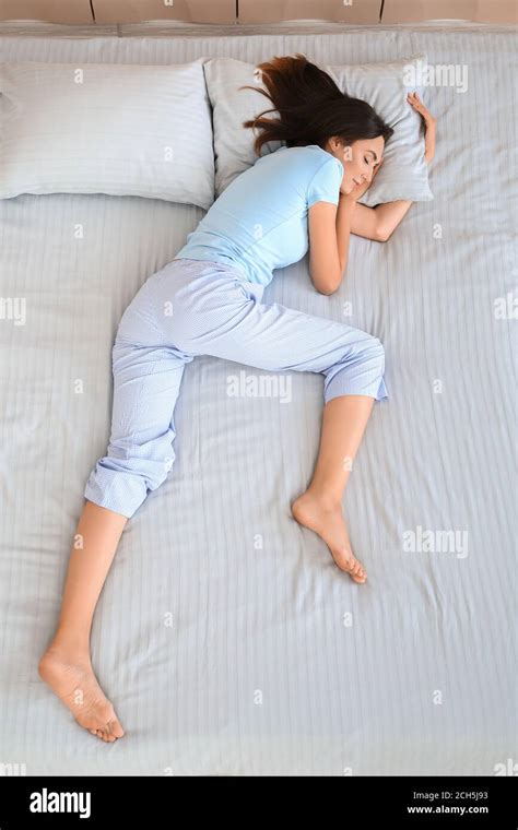 Young woman sleeping in bed, top view Stock Photo - Alamy