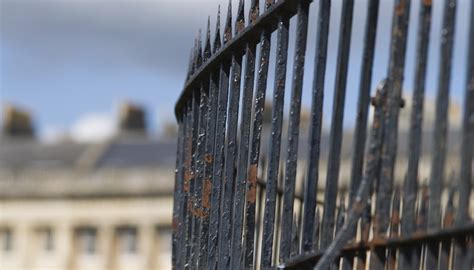 How to Paint a Rusty Metal Fence | Garden Guides