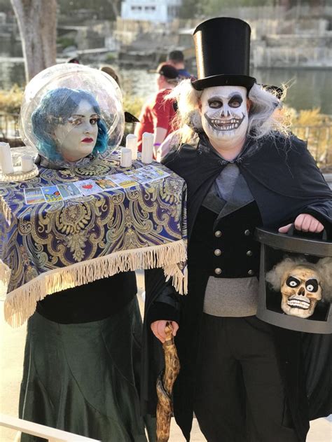 two people dressed up in costumes and holding an item with a skeleton ...