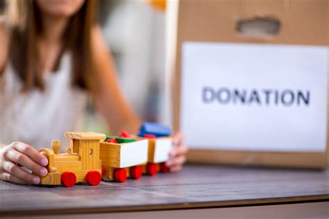 Little girl accepting toy for donation.