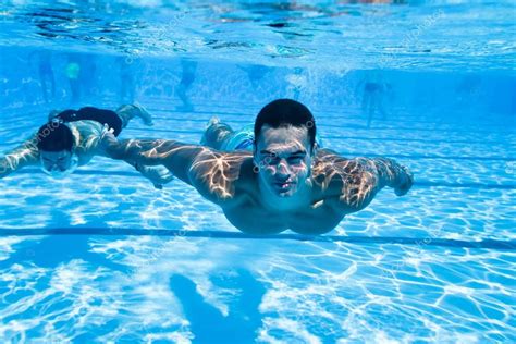 Athletic young men swimming underwater Stock Photo by ©DuxX73 121538172