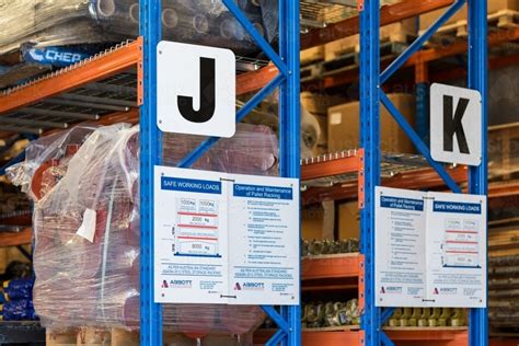 Image of Warehouse shelving and safety signs - Austockphoto