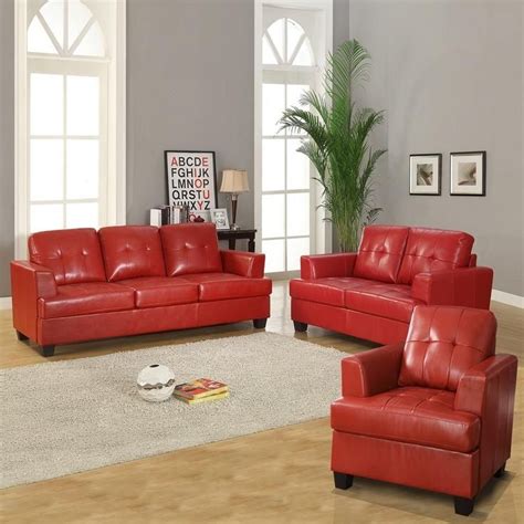 a living room filled with red leather furniture