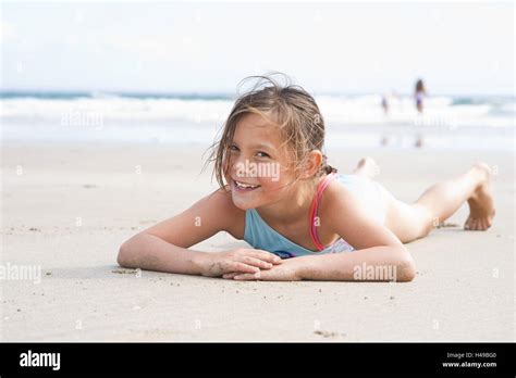 Girl lies on the beach Stock Photo - Alamy