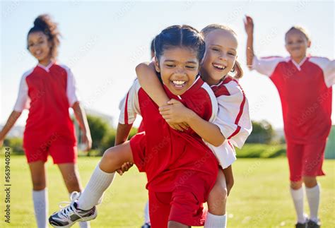 Soccer, girl celebration and field with happy piggyback, team building ...