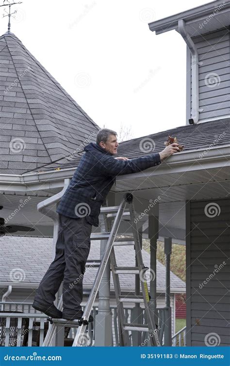 Eaves Trough Cleaning - Home Maintenance Stock Image - Image of cleaning, guttering: 35191183