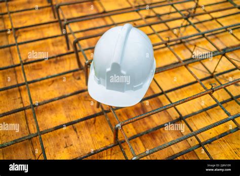 WHITE construction helmet at the construction site Stock Photo - Alamy