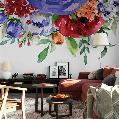 a living room with flowers painted on the wall