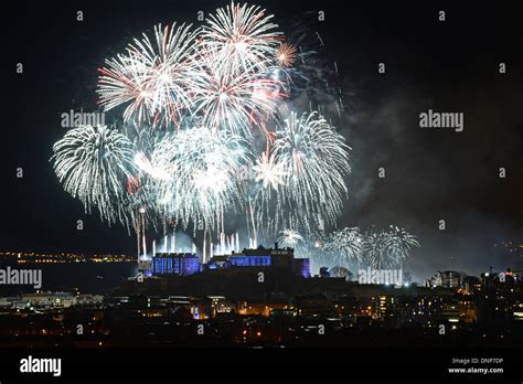 Edinburgh Scotland herald's in the New Year 2014 with a firework's Stock Photo: 65027698 - Alamy