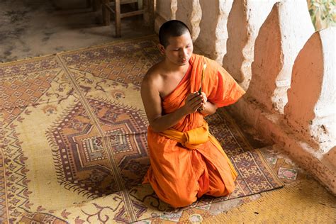 Ira Block Photography | A monk praying at the Pak Ou caves near the Mekong River in Laos.