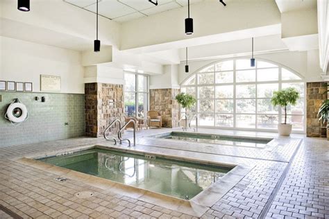 an indoor swimming pool with tiled floors and walls