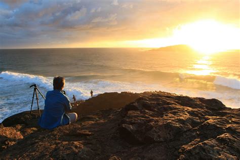 Person Sitting on Cliff Watching Sunset · Free Stock Photo