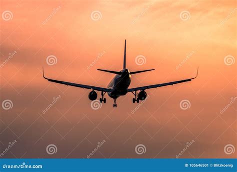 Airplane landing at sunset stock image. Image of a380 - 105646501