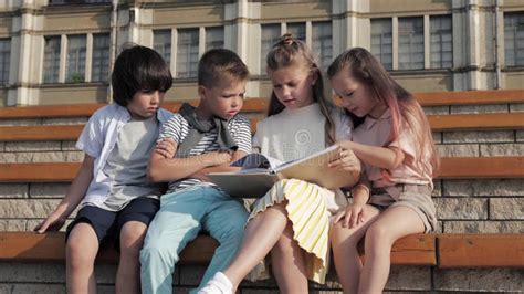 Friendly Group of Kids Reading Book Outdoors. Stock Footage - Video of page, clever: 159219444