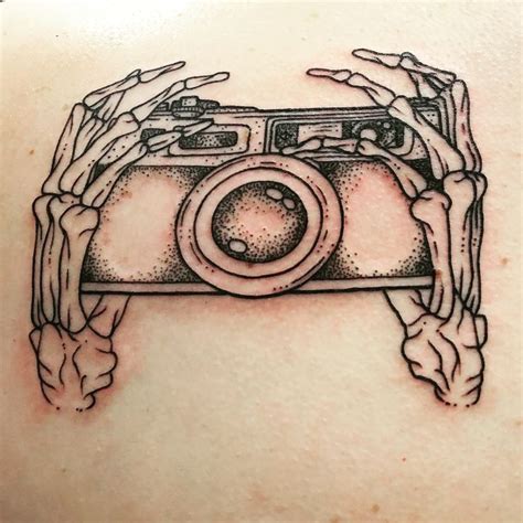 Skeleton hands holding a film camera. New tattoo. I’m in love ...