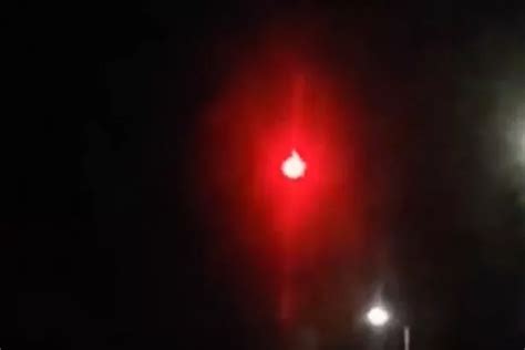 Mysterious fiery red orb filmed zig zagging through night sky over Paris leaves UFO spotters ...