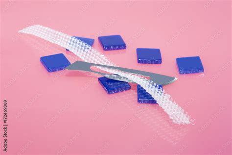 TVT surgery concept. Piece of tension-free vaginal tape and surgical knife Stock Photo | Adobe Stock