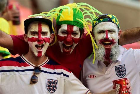 England fans with their faces painted in the colours of their national ...