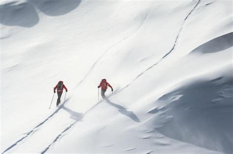 Premium AI Image | Two skiers are going down a snowy mountain.