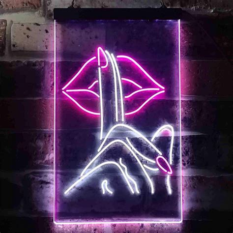 a neon sign that is on the side of a brick wall with a hand holding a ...