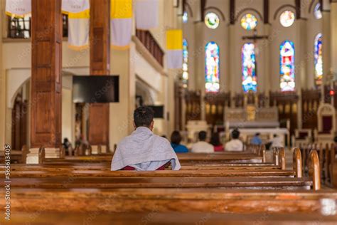 Baguio City, Philippines - A devotee prays inside Our Lady of the ...