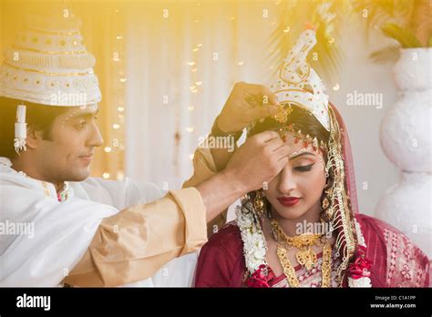 Couple performing Sindoor Daan ceremony in Bengali wedding Stock Photo - Alamy