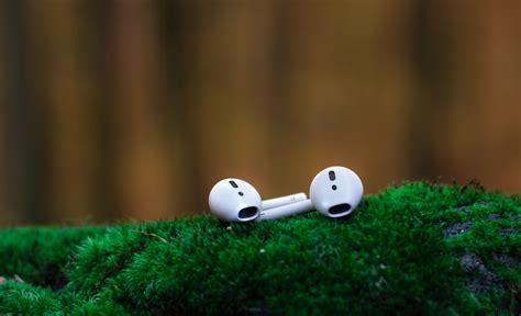 Shallow Focus Photography of White Airpods on Green Surface · Free Stock Photo