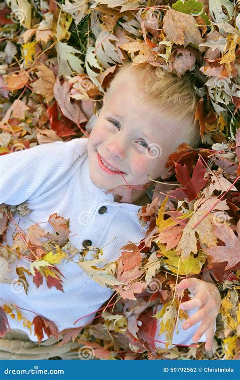 Happy Young Child Jumping in Pile of Fall Leaves Stock Photo - Image of ...