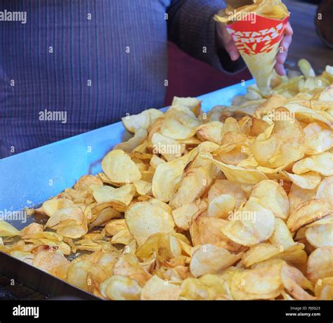 Chips in a black pan with a lot of boiling oil in a restaurant Stock ...