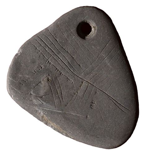 An 11,000-year-old shale pendant engraved with an enigmatic network of ...