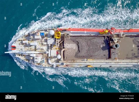 Red Trailing Suction Hopper-Dredger ship roaring across the sea, Aerial image Stock Photo - Alamy