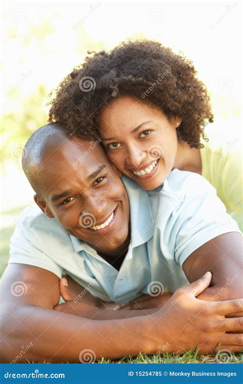 Portrait of Young Couple Laying on Grass in Park Stock Image - Image of couple, lifestyle: 15254785