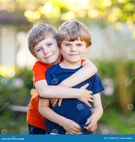 Two Little Active School Kids Boys, Twins and Siblings Hugging on Summer Day. Cute Brothers ...