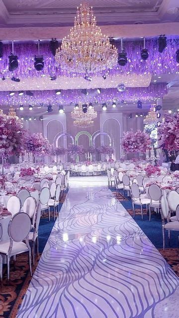 an elaborately decorated banquet hall with chandeliers and tables set ...